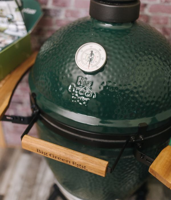 Big Green Egg Keramikgrill mit Thermometer und Holzgriffen in Nahaufnahme.